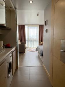a kitchen and a living room with a washer and dryer at studio unit whit pool and gym in Istanbul