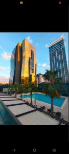 a building with palm trees in front of a building at studio unit whit pool and gym in Istanbul