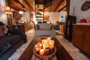 a living room with a table with candles on it at RiverHome in Gávros