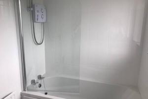 a shower in a bathroom with a glass door at 20 Minutes to the City Center in Dublin