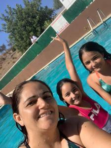 a group of three girls in a swimming pool at Paisagem do Guadiana Turismo Rural in Odeleite