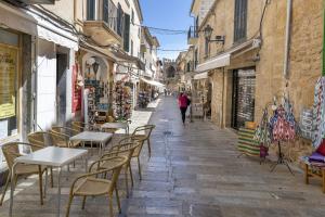 a street with tables and chairs in an alley at Flat in the old town of Alcudia in Alcudia