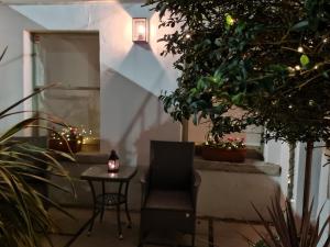 a chair and a table in a courtyard with christmas lights at Pembroke Guest Suite in Dublin
