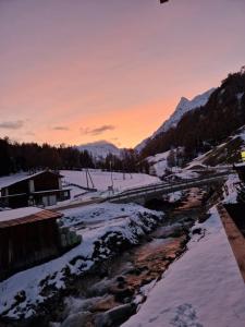 a winter sunset over a river with snow at Chasa Max in Samnaun