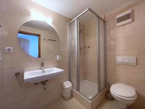 a bathroom with a shower and a sink and a toilet at Hotel Schäffer - Steakhouse Andeo in Gemünden