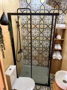 a bathroom with a shower with a toilet and a sink at PicoTerrace View in Madalena +9 photos