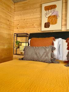 a bedroom with a bed with a yellow comforter at PicoTerrace View in Madalena