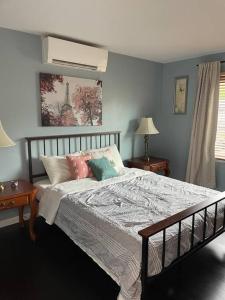 a bedroom with a bed with pillows on it at Home with Free Tesla Charger in Christiana in Newark