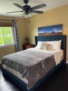 a bedroom with a bed with a ceiling fan at Home with Free Tesla Charger in Christiana in Newark
