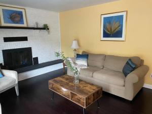 a living room with a couch and a coffee table at Home with Free Tesla Charger in Christiana in Newark