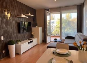 a living room with a couch and a tv at VIP MINI RESORT,Private Parking & Balcony in Budapest