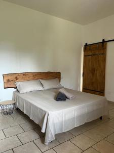 um quarto com uma grande cama branca e uma cabeceira em madeira em Az. Agricola Agriturismo Lo Schiucciolo em San Donato