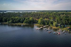 an aerial view of a dock with boats on the water at Blockbohlenhaus bei Potsdam in Schwielowsee