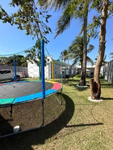 a trampoline in a park with palm trees at Cantinho do sossego in Porto Seguro