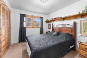 a bedroom with a black bed and a window at 3 bedroom duplex by Sanford in Sioux Falls