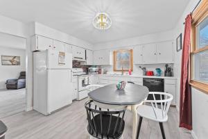 a kitchen with a table and a white refrigerator at 3 bedroom duplex by Sanford in Sioux Falls