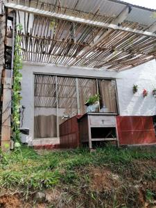 an outside view of a house with a table and a window at Glamping Bambulina in Cali