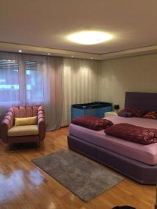 a bedroom with two beds and a couch and a chair at Luxury House with big garden and mountain view ( 3 bedrooms) in Haag