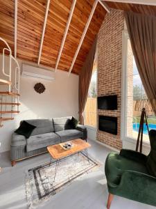 a living room with a couch and a table at WONDERLAND TİNY HOUSE in Sapanca