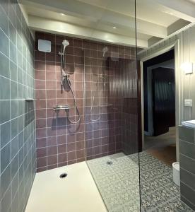 a bathroom with a shower with purple tiles at Cabanes avec jacuzzi les pieds dans la vignes 