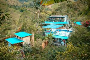 an overhead view of a resort with blue roofs at Cabaña / hotel campestre en Manizales para pareja in Manizales