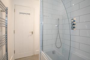 a bathroom with a shower with a glass door at ENTR - Modern Apartments in Windsor with Parking in Windsor