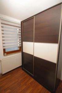 a black and white closet in a room with a window at Apartman Alchemist I in Bosanska Dubica