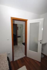 a room with a door and a bathroom with a toilet at Apartman Alchemist I in Bosanska Dubica