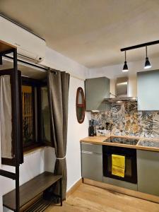 a kitchen with a stove and a counter top at Happie Casa La Cattedrale in Palermo