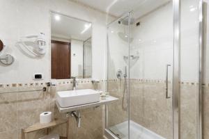 a bathroom with a sink and a shower at Esposizione Luxury Rome in Rome