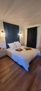 a large white bed with two pillows on top of it at Aqua Rêve in Digne-les-Bains