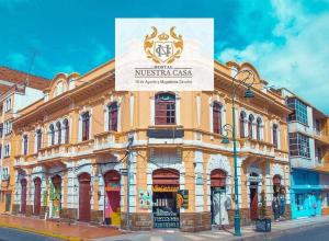 a building with a sign on the side of it at Hotel Nuestra Casa Riobamba in Riobamba