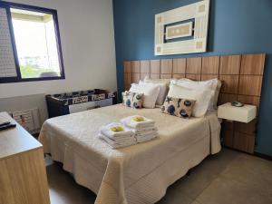 a bedroom with a bed with towels on it at Apartamento Barra Pé na Areia in Rio de Janeiro