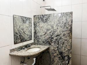 a bathroom with a sink and a mirror at Status Motel in Niterói +14 photos
