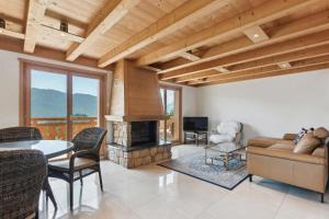 a living room with a couch and a fireplace at Winterfell in Leysin