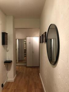 a hallway with a round mirror on a wall at Appartement 2 chambres centre MORZINE in Morzine