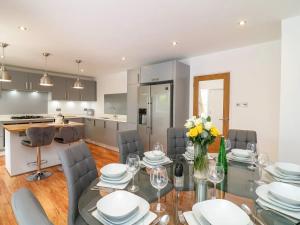 a kitchen and dining room with a glass table and chairs at Beautiful Whole Home in Torbay, Walking Distance to Beach, Centre and Harbour in Torquay