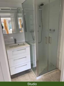 a white bathroom with a shower and a sink at Maison 8 pers 1 minute parc des expositions in Bohars