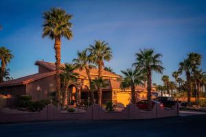 a house with palm trees in front of it at Z House in Las Vegas