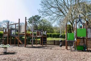 a park with a playground with a slide at Wharfe Lodge in Skipton