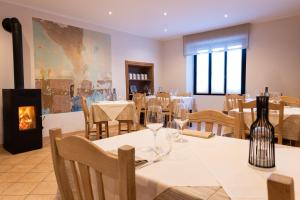 a restaurant with tables and chairs and a fireplace at La Stazione in Trontano