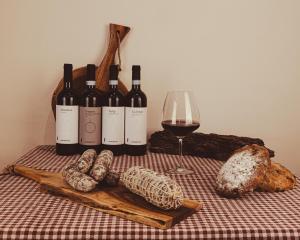 stół z butelkami wina i kieliszkiem wina w obiekcie La Stazione w mieście Trontano