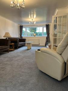 a living room with a couch and a table at Wendover House 