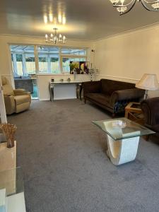 a living room with a couch and a table at Wendover House 