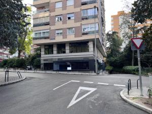an empty parking lot in front of a building at Rooms Luxury Madrid in Madrid