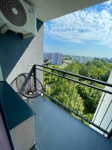 a balcony with a fan and a chair on a balcony at Apartmán v meste Michalovce in Michalovce