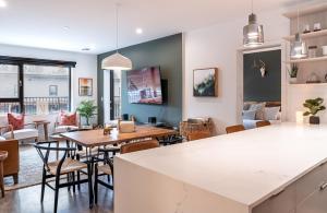 a kitchen and living room with a table and chairs at Hemlock Hangout by Revelstoke Vacations in Revelstoke