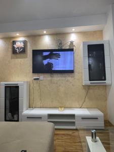 a living room with a flat screen tv on the wall at Stan na dan Bratunac in Bratunac