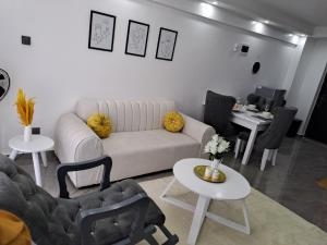 a living room with a couch and tables at Cozy 2 bedroom apartment With gym &washer near yaya centre in Nairobi