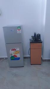 a refrigerator and a counter in a room at Cozy 2 bedroom apartment With gym &washer near yaya centre in Nairobi